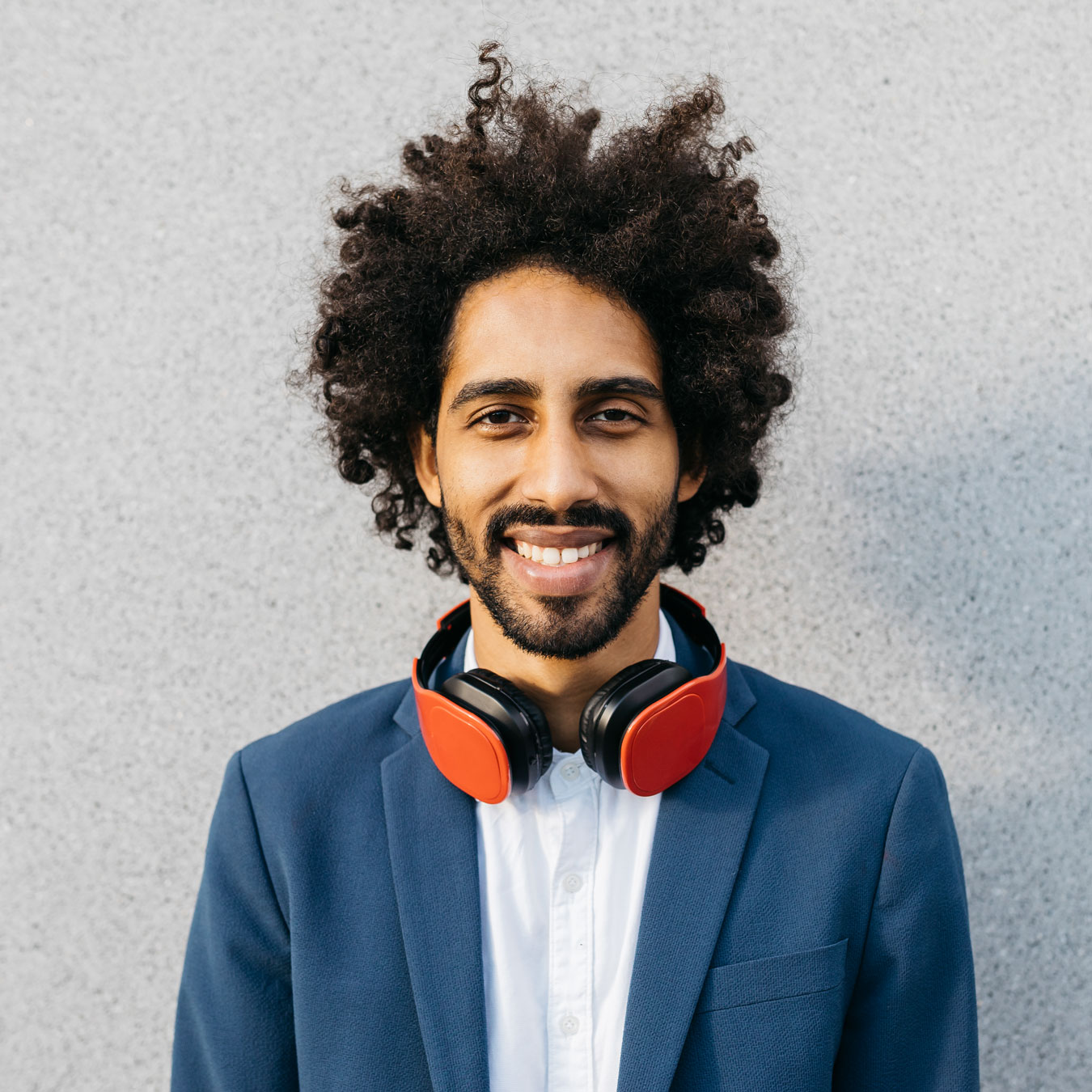 portrait-of-smiling-young-businessman-with-headpho-2022-03-08-01-25-01-utc.jpg